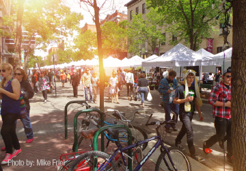 Thriving farmers' market during a beautiful sunny day. South-facing view of 104 Street, with Jasper Avenue in the background.